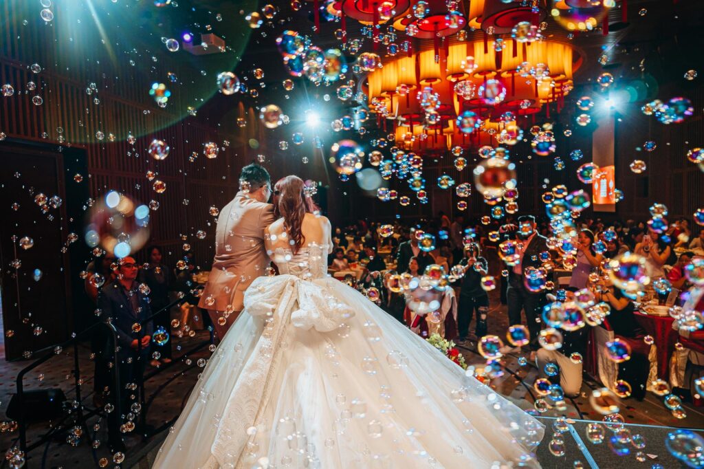 Beautiful bubbles fill the stage as the couple pours the champagne tower.
