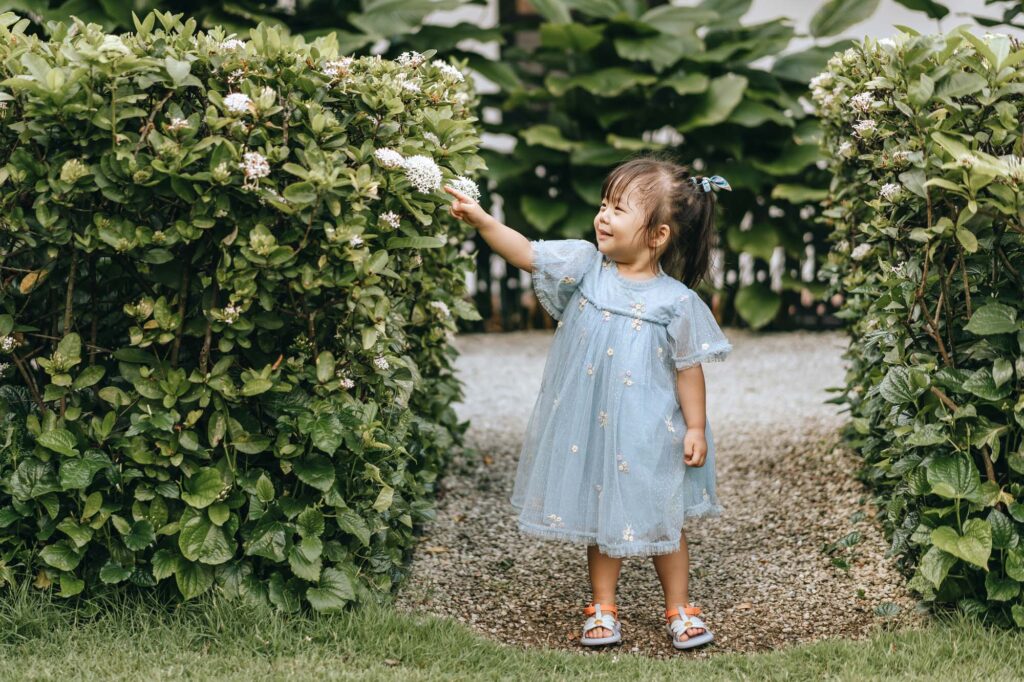Photo of a Cute little girl playing at the raffles Hotel Lawn.