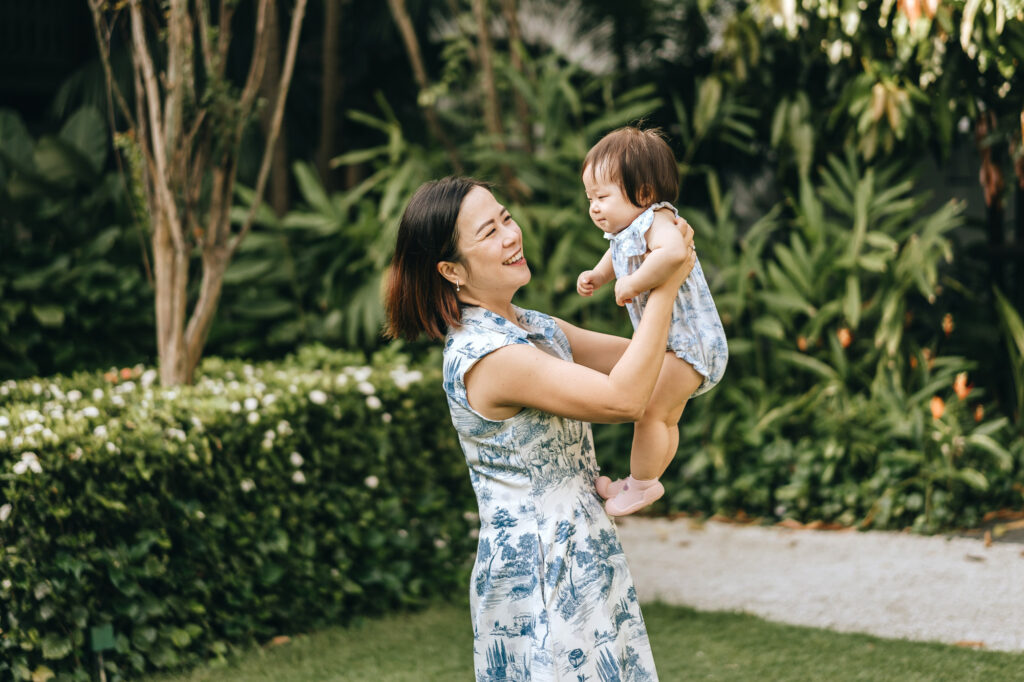 Photo of a mother playing with her baby, taken at the Raflles Hotel Singapore.