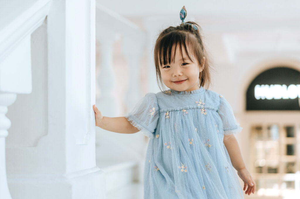 Photo of a cute little girl at the Raffles hotel white granite staircase.