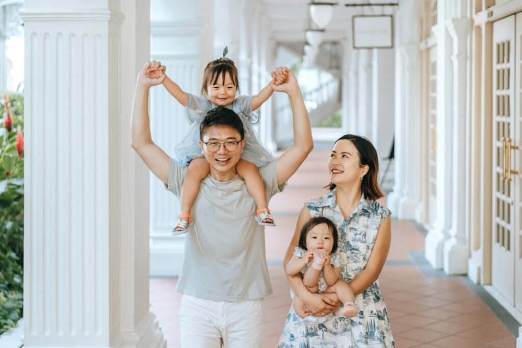 Happy family during their photo shoot at the Raffles Hotel arcade.
