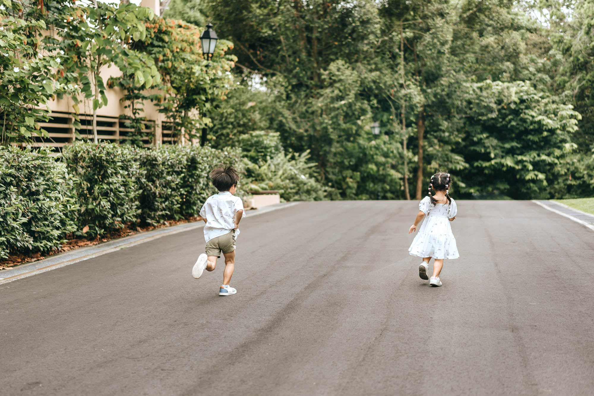 kids running during family photo shoot at singapore botanic gardens
