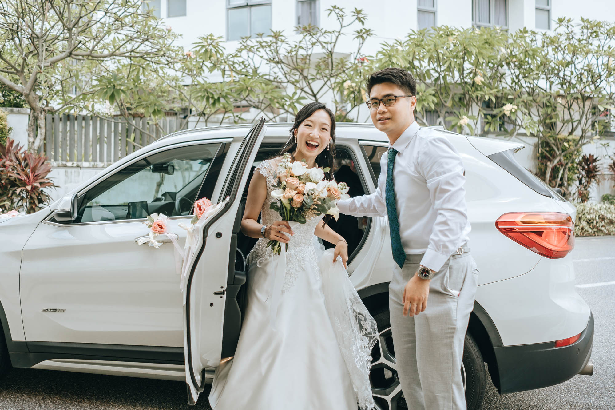 the happy couple getting off the bridal car