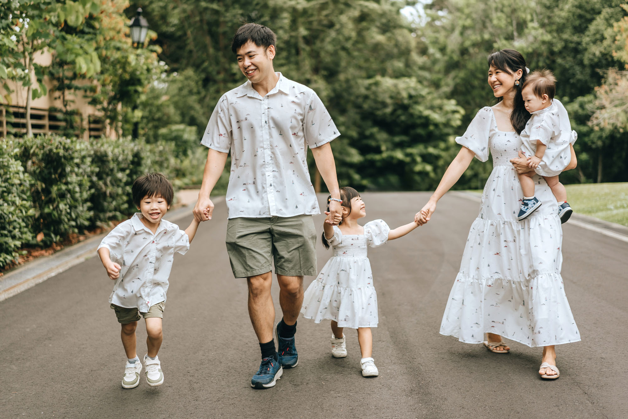 happy family all holding hands and running