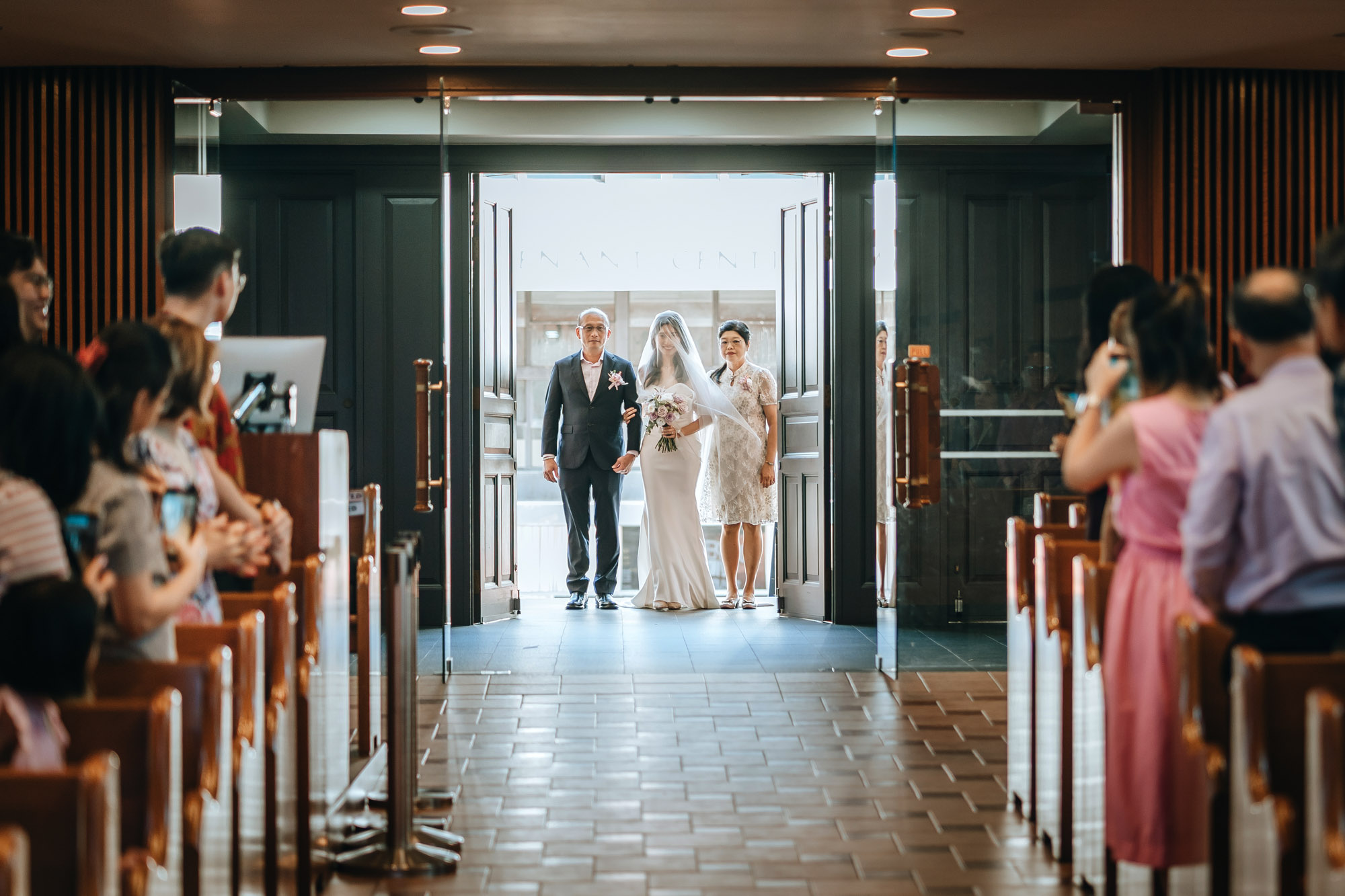 the bride and her parents getting ready to enter