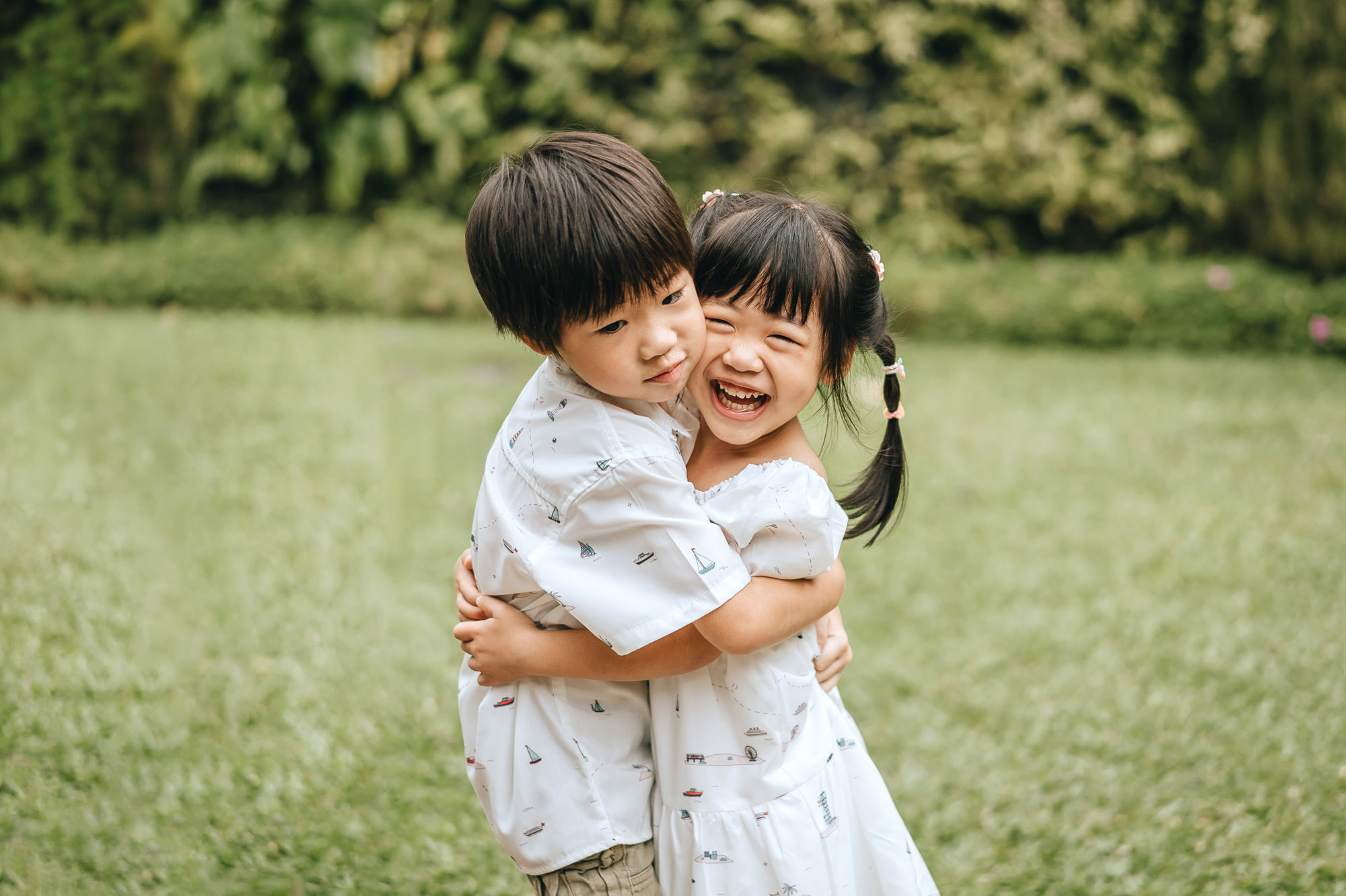 siblings hugging and laughing