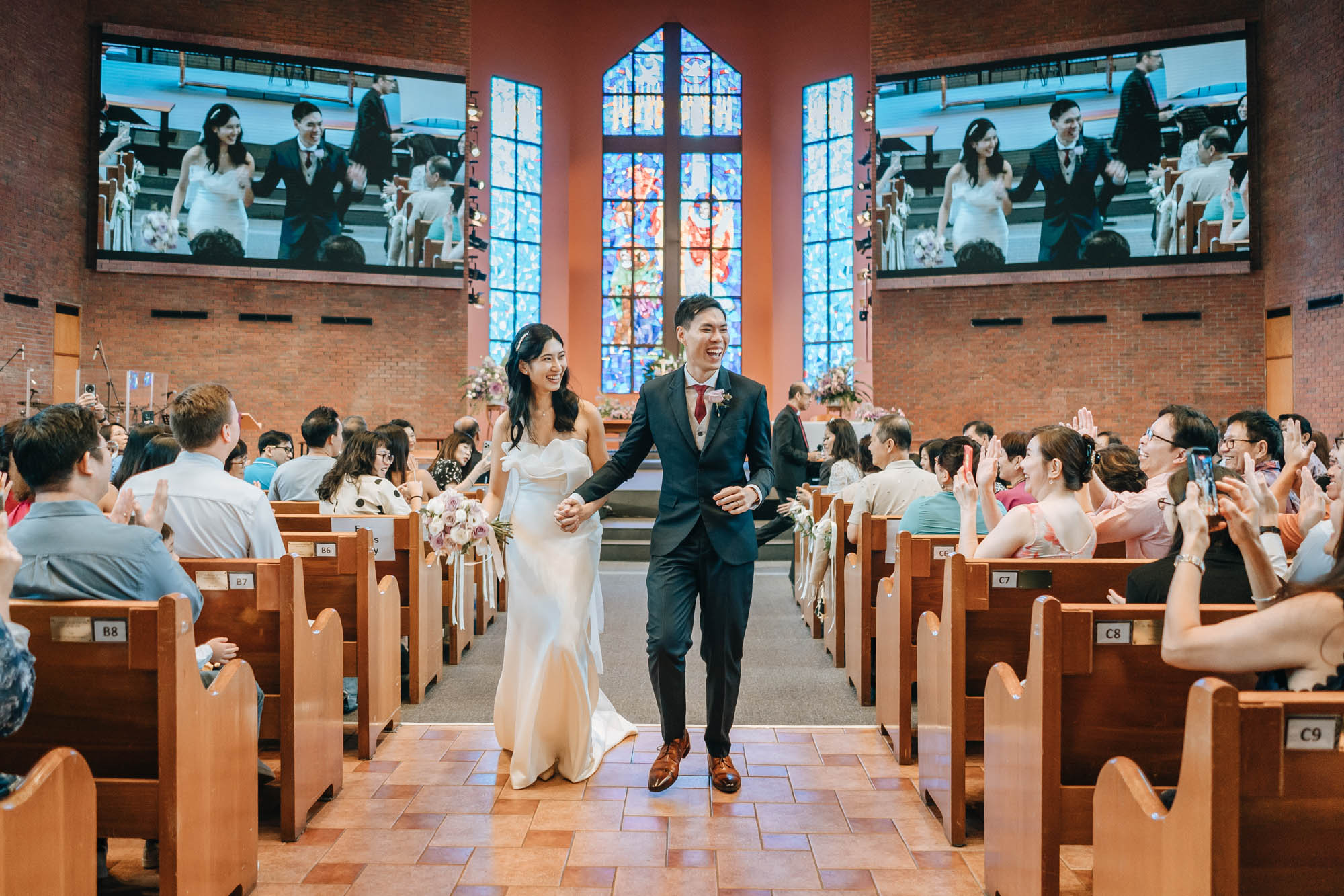 the newly weds marching out to cheers and clapping