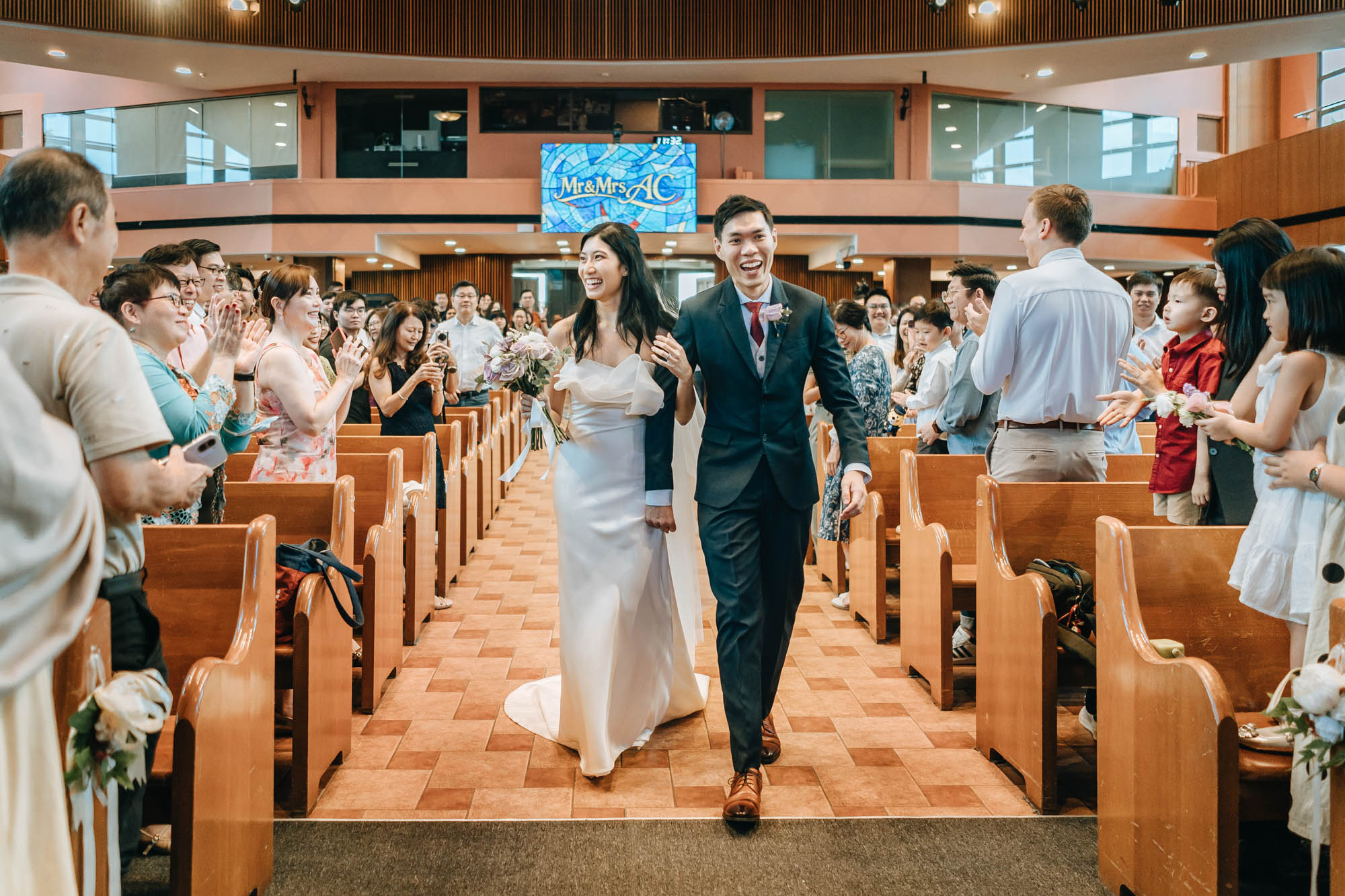 happy newly wedded couple walking down the aisle