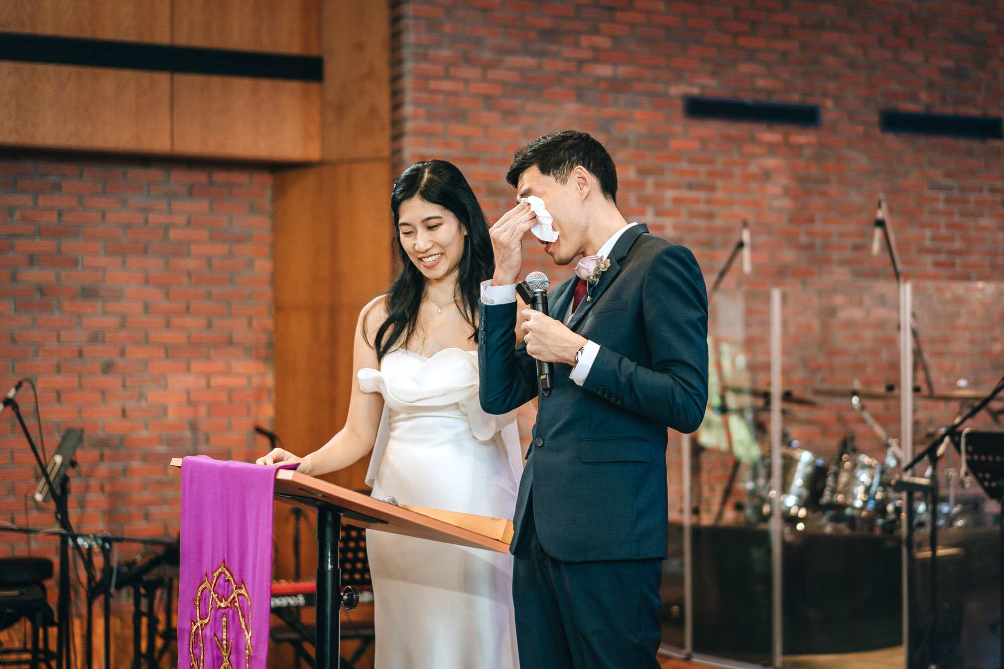 the groom dries his eyes during a touching speech