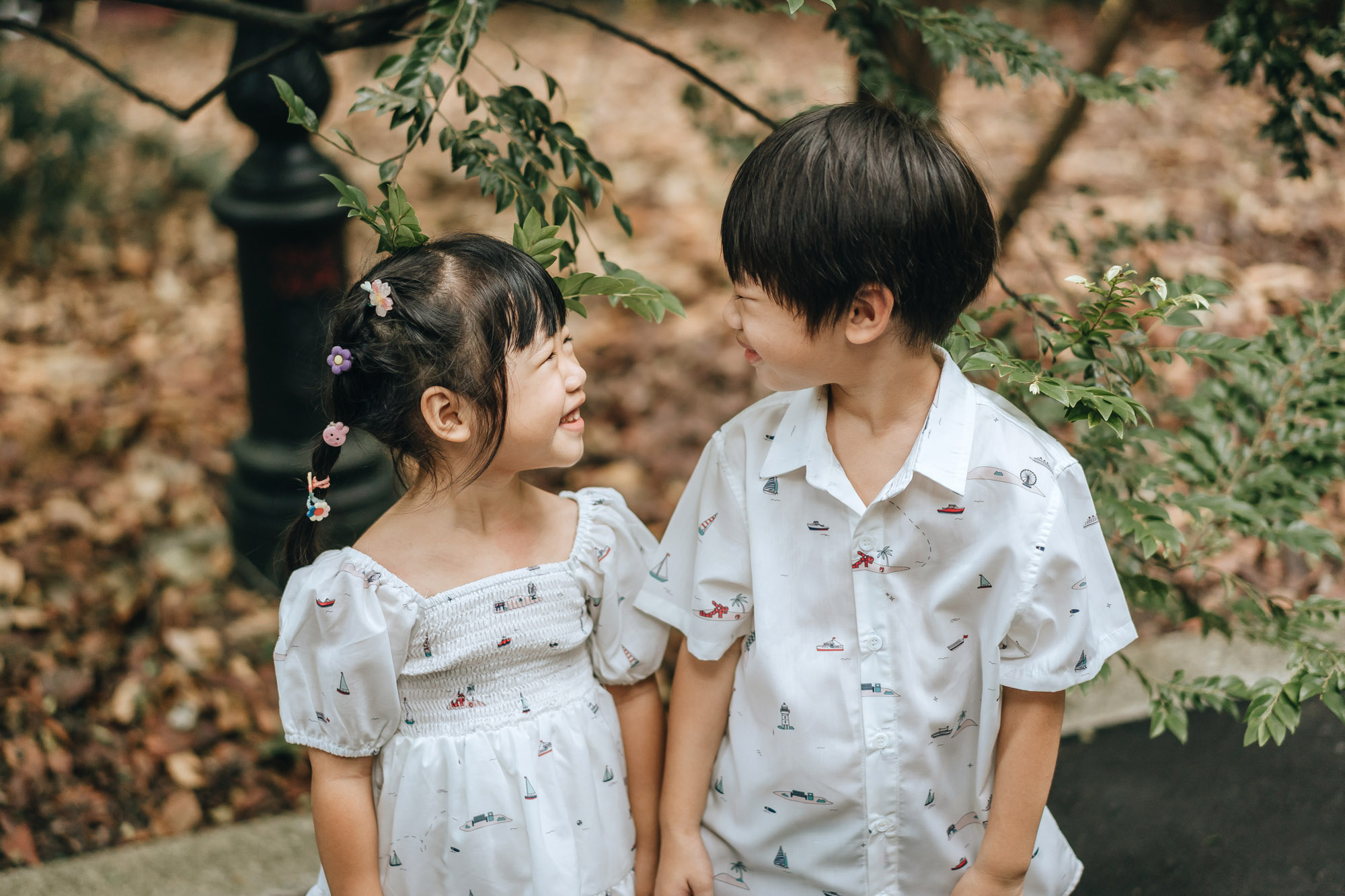 sibling holding hands and smiling