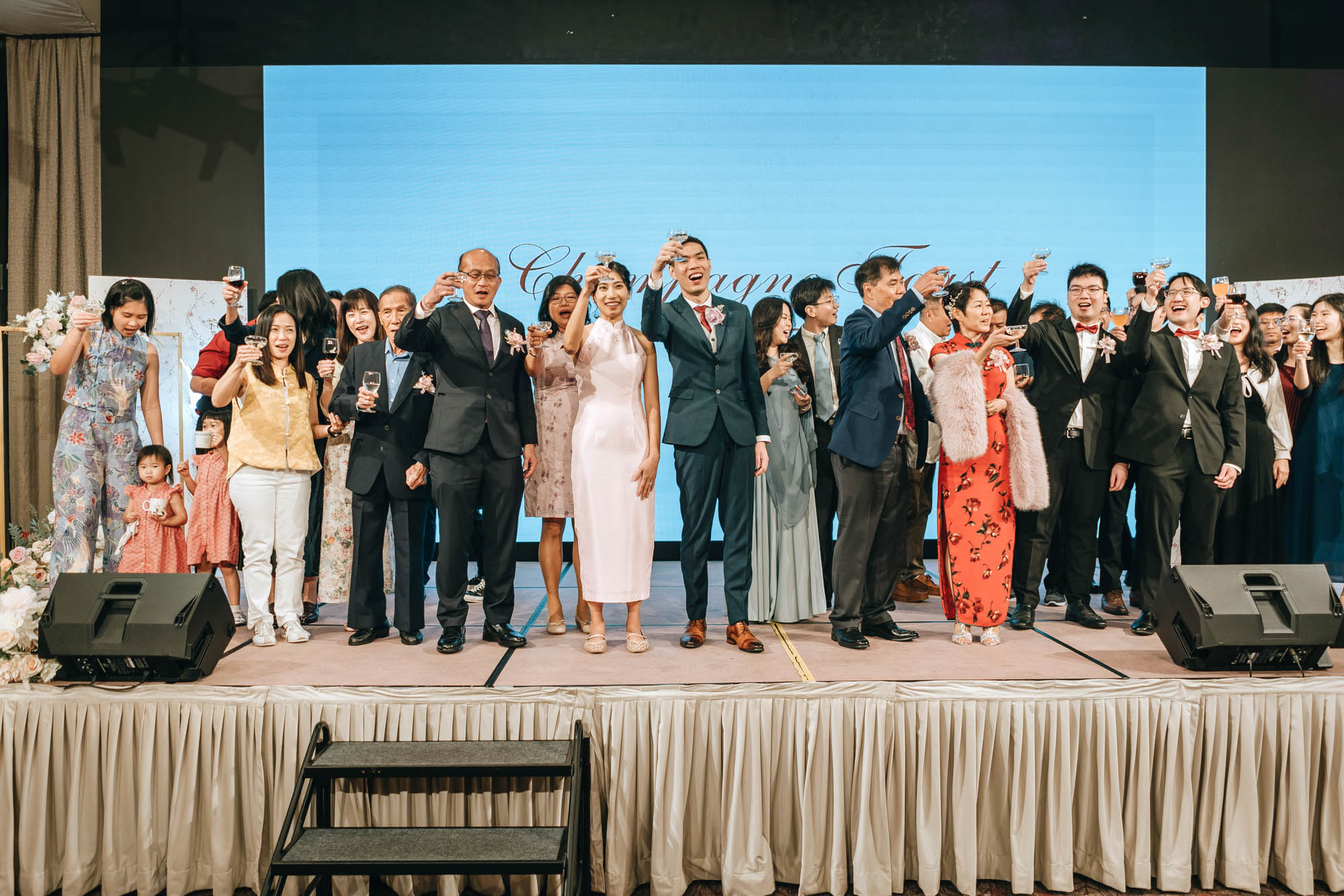 family and bridal party toasts the guests with traditional chinese yumseng