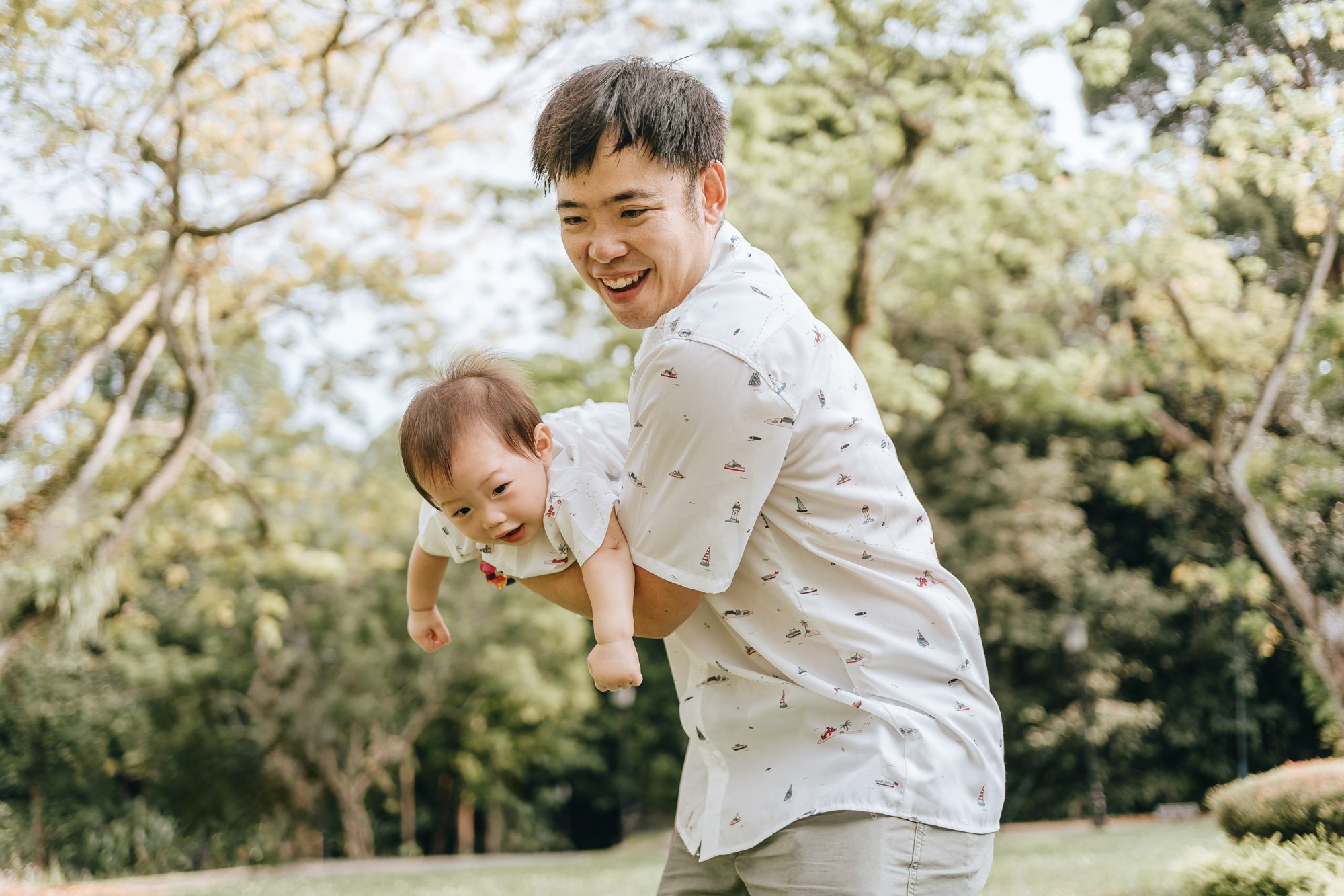 happy father playing with baby son