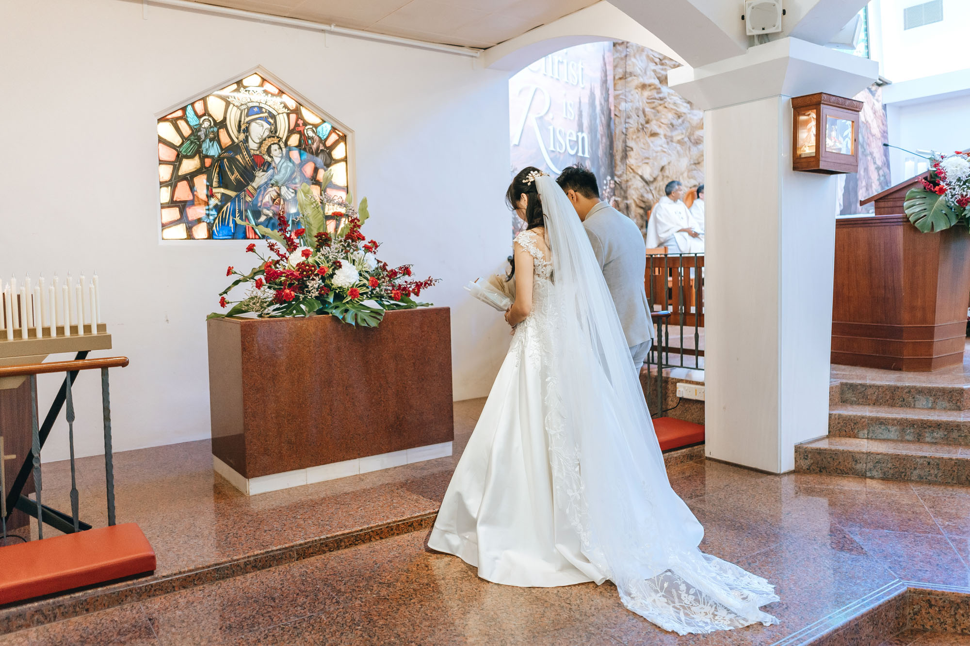 the newly weds making an offering to st. mary