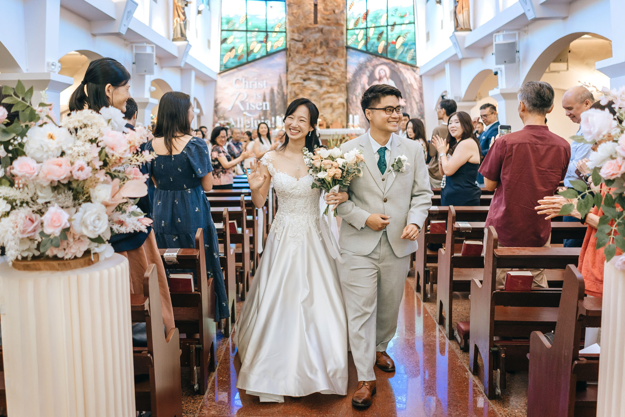 the newly wedded couple marches down the aisle