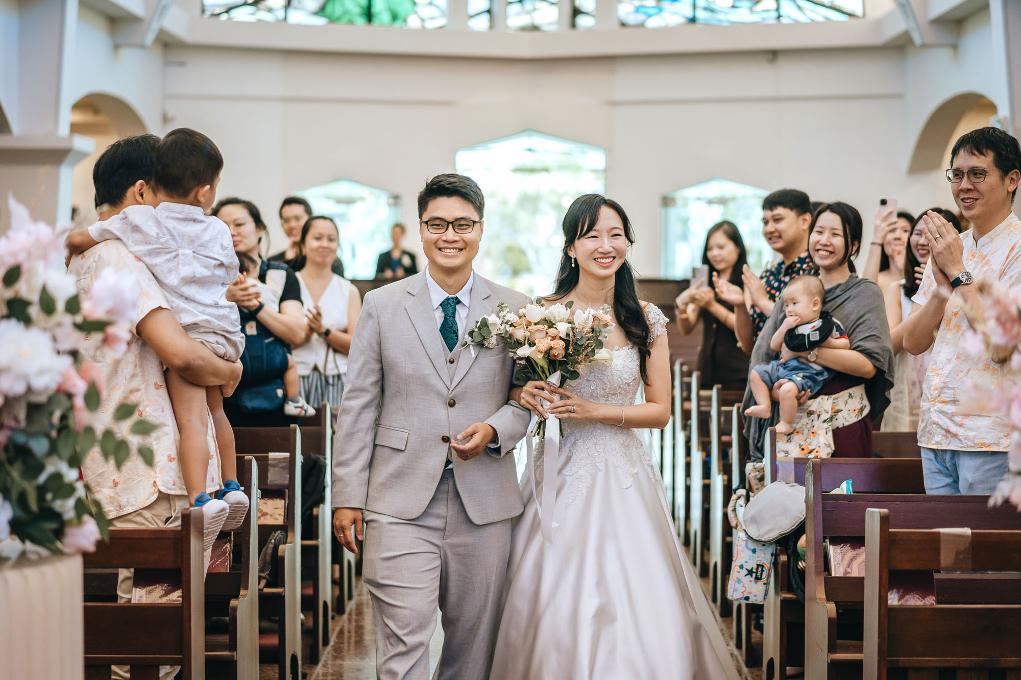 the newly weds marches down the aisle to claps and cheers