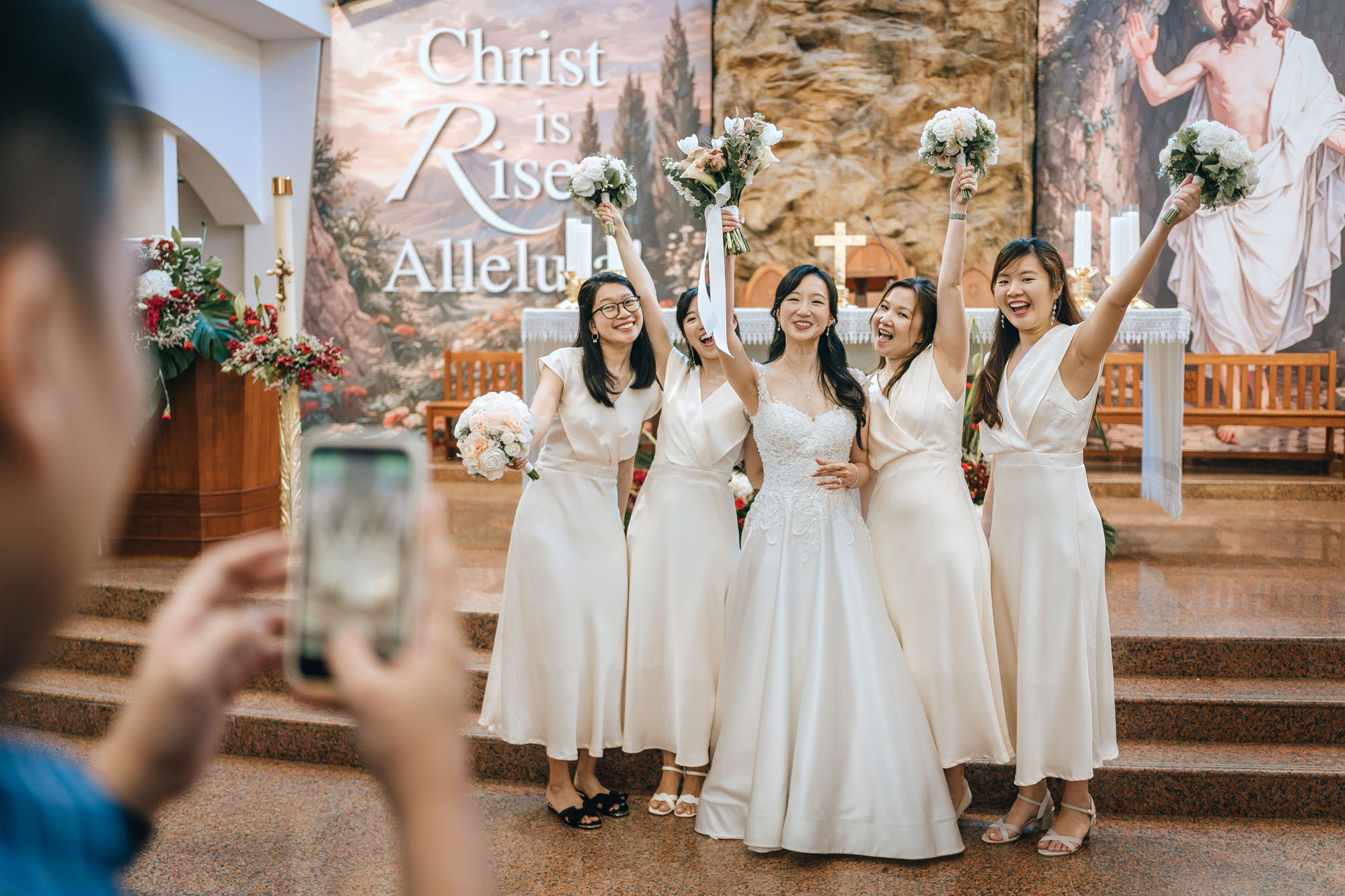 the bride and bridesmaids taking photos